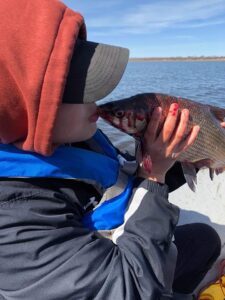 boy kissing fish